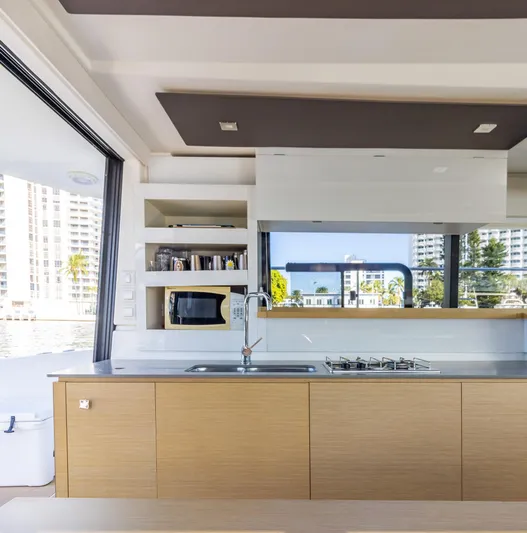 Floripa Yacht Photos Pics Modern kitchen interior on 2017 Fountaine Pajot MY 37 yacht, featuring sleek cabinetry and appliances.