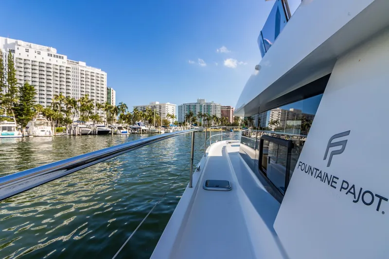 Floripa Yacht Photos Pics 2017 Fountaine Pajot MY 37 yacht docked near waterfront buildings under clear blue sky.