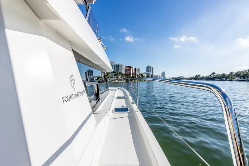 Floripa Yacht Photos Pics 2017 Fountaine Pajot MY 37 yacht on water, city skyline in background, sunny day.