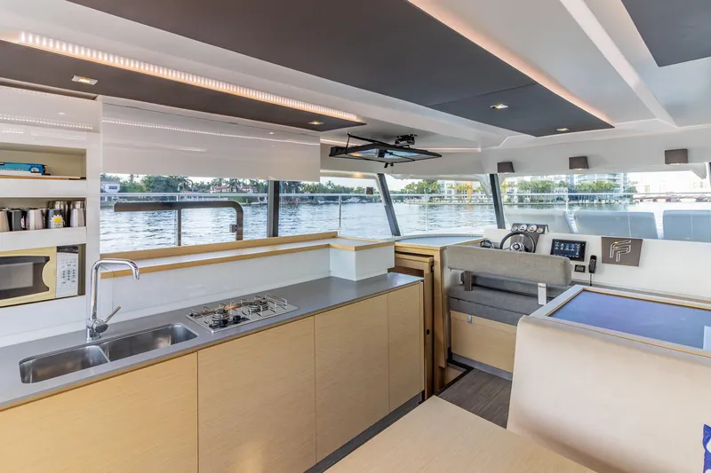 Floripa Yacht Photos Pics Modern interior of 2017 Fountaine Pajot MY 37 yacht with kitchen and helm.