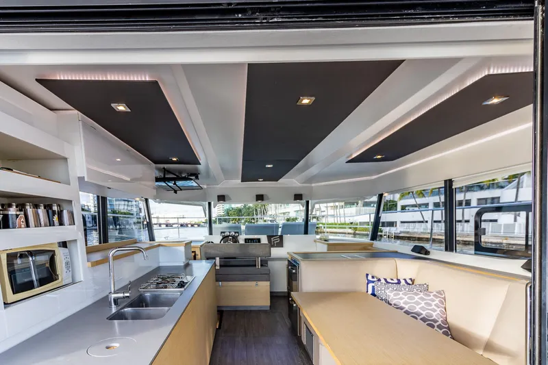 Floripa Yacht Photos Pics Luxurious interior of 2017 Fountaine Pajot MY 37 yacht with modern kitchen and seating area.