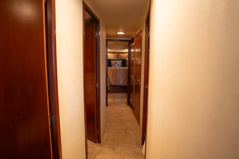Bloodline Yacht Photos Pics Hallway inside 1990 Hatteras 58 Convertible yacht, leading to a cozy bedroom.