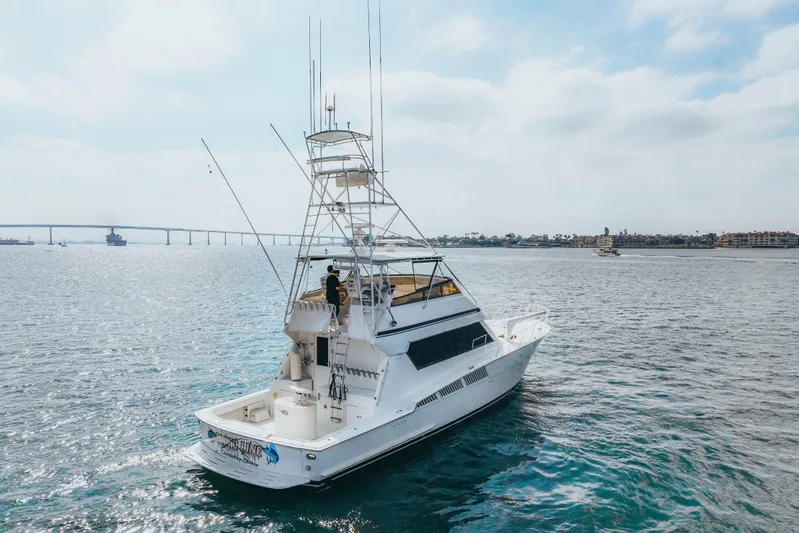 Bloodline Yacht Photos Pics 1990 Hatteras 58 Convertible yacht cruising on open water under a clear sky.