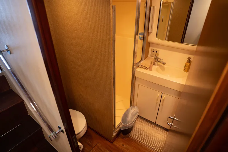 Bloodline Yacht Photos Pics Bathroom interior of 1990 Hatteras 58 Convertible yacht, featuring sink, toilet, and shower.
