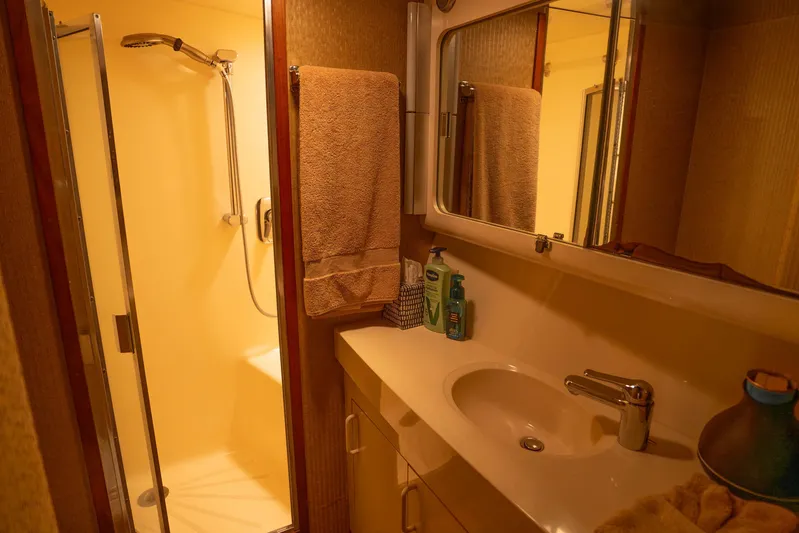Bloodline Yacht Photos Pics Bathroom interior of 1990 Hatteras 58 Convertible yacht with shower and sink.