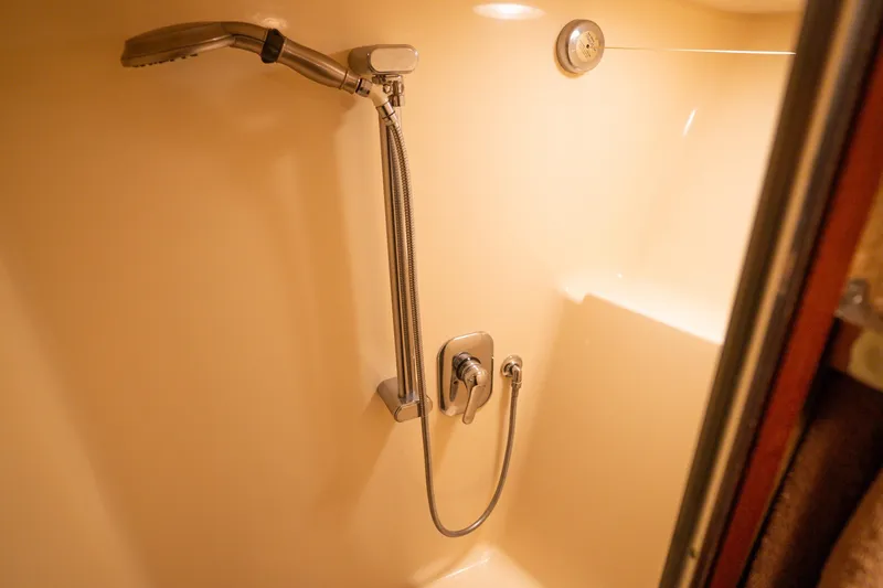 Bloodline Yacht Photos Pics Shower area in 1990 Hatteras 58 Convertible yacht, featuring modern fixtures.