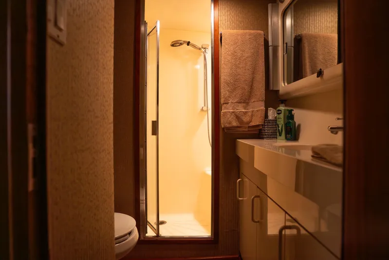 Bloodline Yacht Photos Pics Bathroom interior of 1990 Hatteras 58 Convertible yacht, featuring shower and vanity.