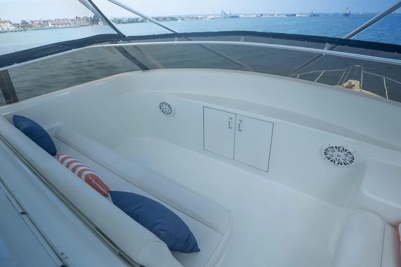 Bloodline Yacht Photos Pics 1990 Hatteras 58 Convertible yacht interior with seating and cushions, overlooking the water.