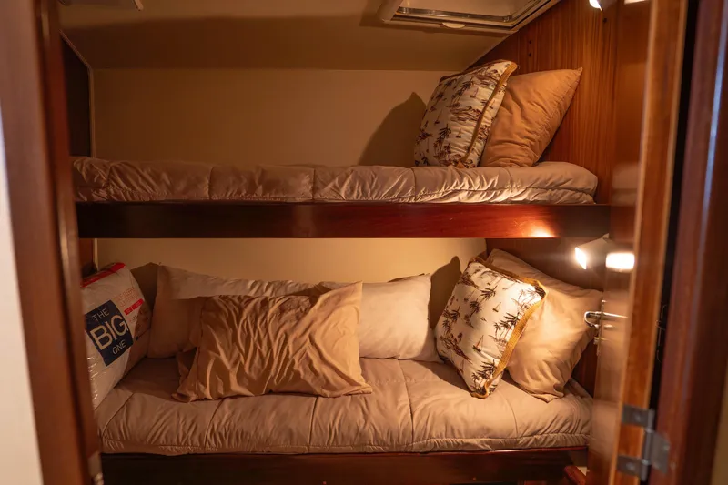 Bloodline Yacht Photos Pics Bunk beds in a cozy cabin of a 1990 Hatteras 58 Convertible yacht.