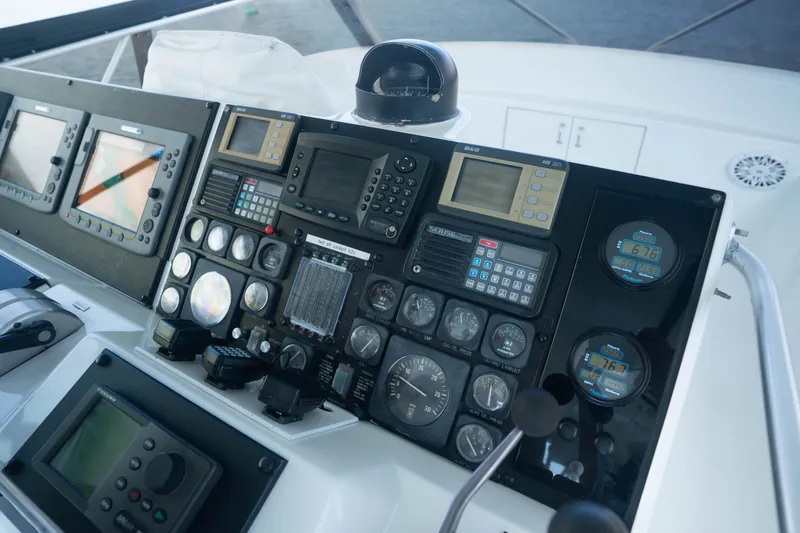 Bloodline Yacht Photos Pics Control panel of a 1990 Hatteras 58 Convertible yacht with navigation instruments.