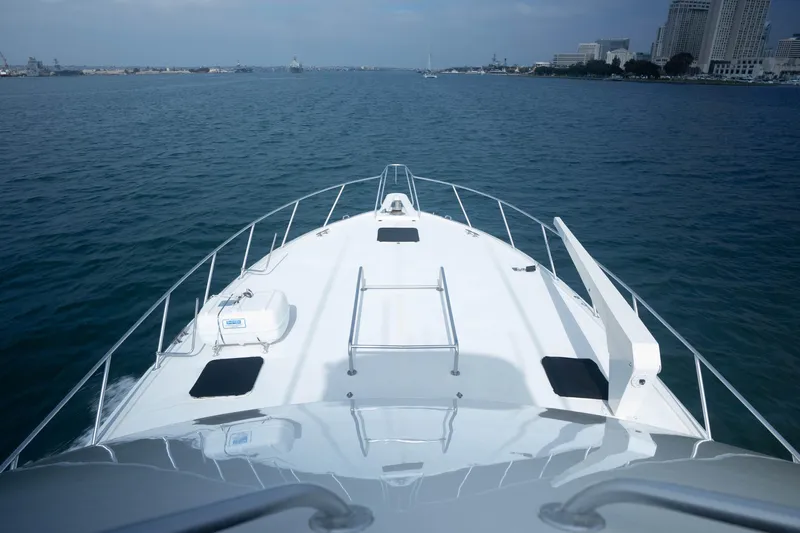 Bloodline Yacht Photos Pics Bow view of 1990 Hatteras 58 Convertible yacht cruising in open water.
