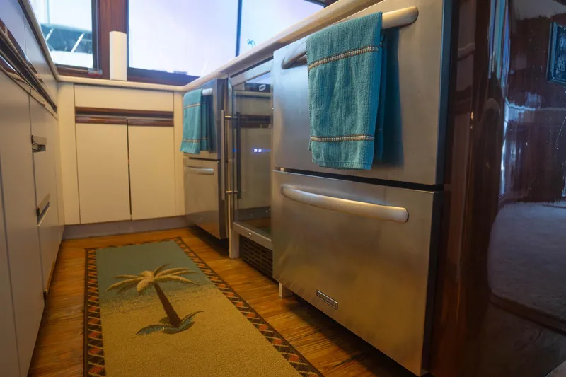 Bloodline Yacht Photos Pics Luxurious kitchen interior of 1990 Hatteras 58 Convertible yacht with modern appliances.