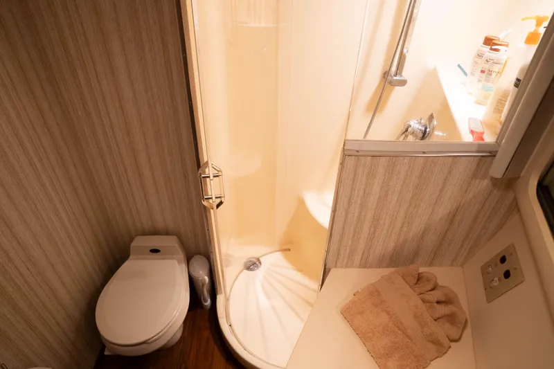 Bloodline Yacht Photos Pics Bathroom interior of 1990 Hatteras 58 Convertible yacht with shower and toilet.