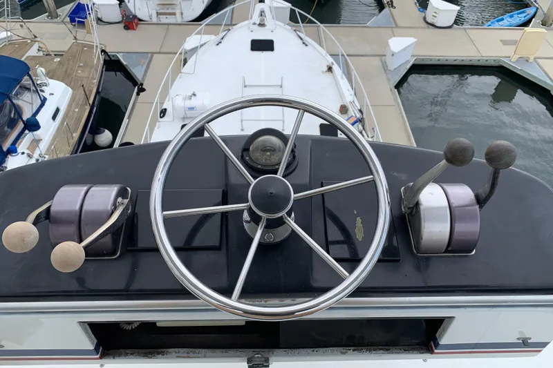 Bloodline Yacht Photos Pics Helm of 1990 Hatteras 58 Convertible yacht with steering wheel and controls.