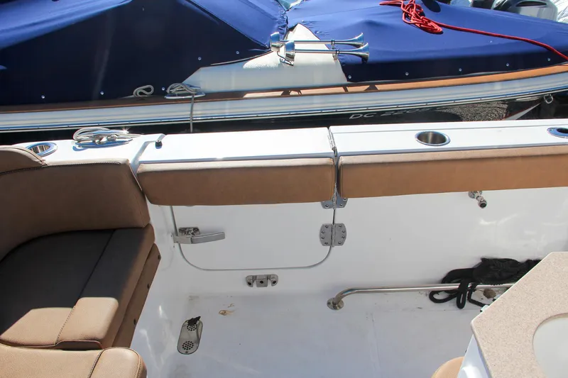  Yacht Photos Pics 2021 Sea Hunt Ultra 275 SE boat interior with cushioned seating and storage compartments.