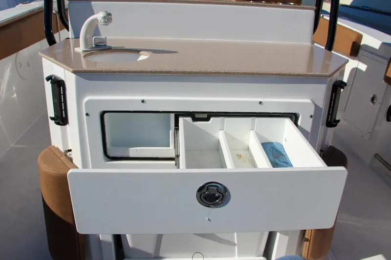  Yacht Photos Pics 2021 Sea Hunt Ultra 275 SE boat with open storage drawer and sink.