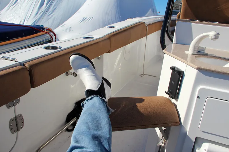  Yacht Photos Pics Person relaxing on a 2021 Sea Hunt Ultra 275 SE boat with feet up.