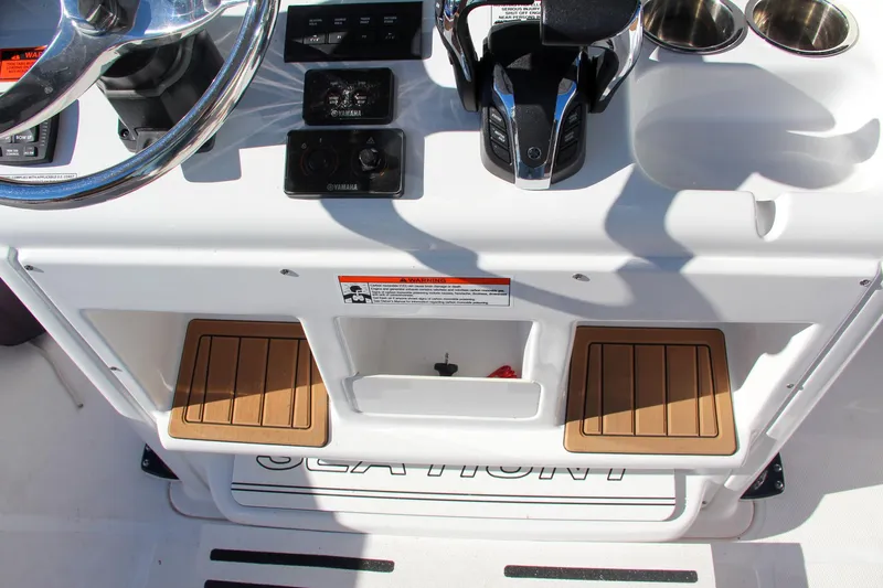  Yacht Photos Pics 2021 Sea Hunt Ultra 275 SE helm station with controls and storage.