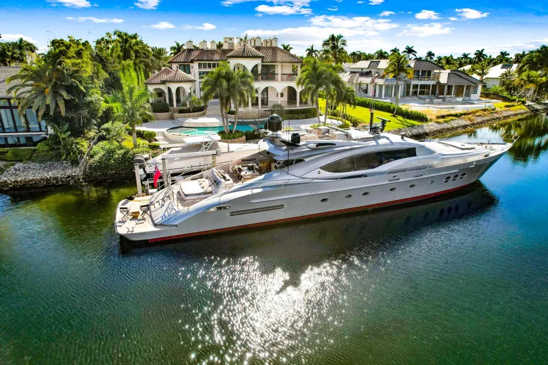 Izumi Yacht Photos Pics Palmer Johnson 120 Sports Cruiser 2008 yacht docked by luxurious waterfront mansion.