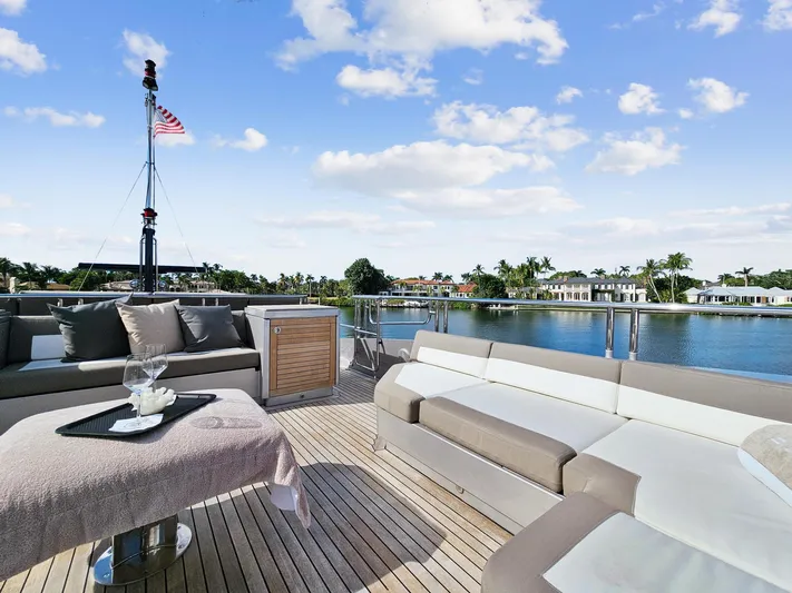 Izumi Yacht Photos Pics Luxurious deck of 2008 Palmer Johnson 120 Sports Cruiser with waterfront view.
