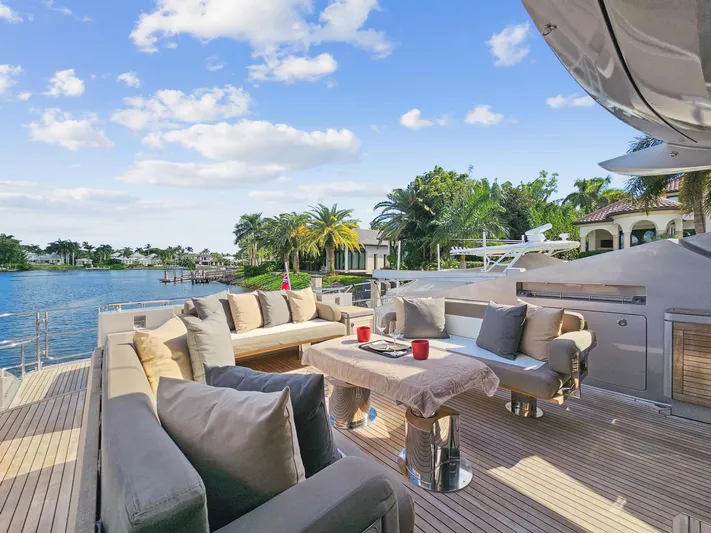 Izumi Yacht Photos Pics Luxurious deck of 2008 Palmer Johnson 120 Sports Cruiser yacht with plush seating and scenic waterfront view.