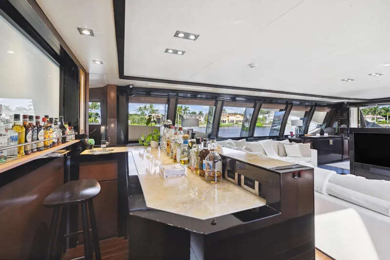 Izumi Yacht Photos Pics Luxurious interior of 2008 Palmer Johnson 120 Sports Cruiser with bar and panoramic windows.