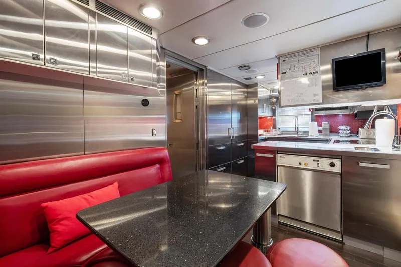 Izumi Yacht Photos Pics 2008 Palmer Johnson 120 Sports Cruiser kitchen with stainless steel appliances and red seating.