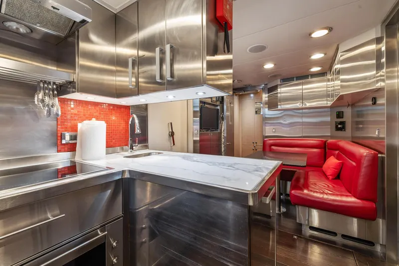 Izumi Yacht Photos Pics Modern kitchen and dining area in 2008 Palmer Johnson 120 Sports Cruiser yacht.