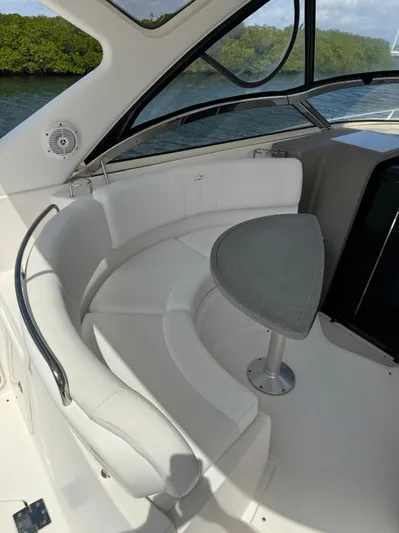  Yacht Photos Pics 2006 Regal Commodore 3560 IO boat interior with curved seating and small table.