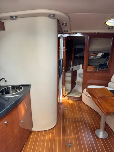  Yacht Photos Pics Interior of 2006 Regal Commodore 3560 IO yacht with wood flooring and kitchenette.