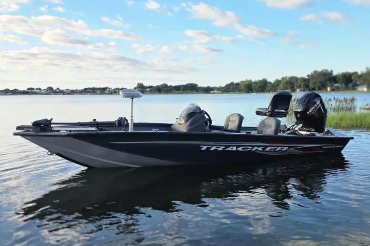 2020 Tracker Pro Team 175 TF boat on a calm lake under a blue sky.