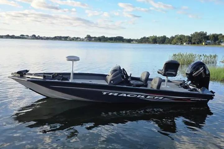 2020 Tracker Pro Team 175 TF boat on a calm lake under a blue sky.