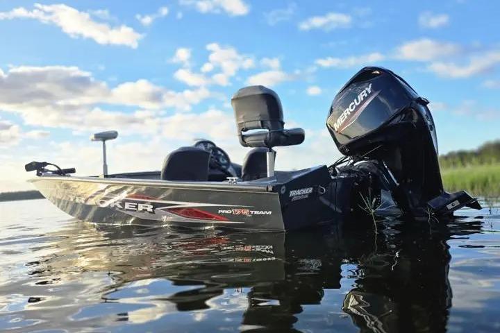 2020 Tracker Pro Team 175 TF boat on calm water under blue sky.