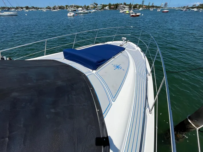 Lazy Days Yacht Photos Pics 2009 Sea Ray 44 Sedan Bridge yacht on calm waters with other boats in the background.
