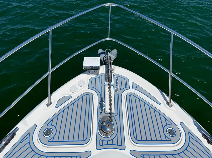 Lazy Days Yacht Photos Pics Bow of 2009 Sea Ray 44 Sedan Bridge yacht with anchor and blue deck.