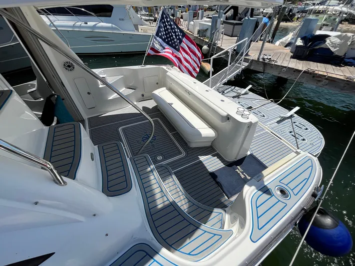 Lazy Days Yacht Photos Pics 2009 Sea Ray 44 Sedan Bridge yacht with American flag at marina.