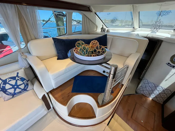 Lazy Days Yacht Photos Pics Luxurious interior of 2009 Sea Ray 44 Sedan Bridge yacht with white seating and nautical decor.