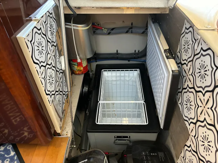 Lazy Days Yacht Photos Pics Open storage compartment on a 2009 Sea Ray 44 Sedan Bridge yacht with patterned walls.