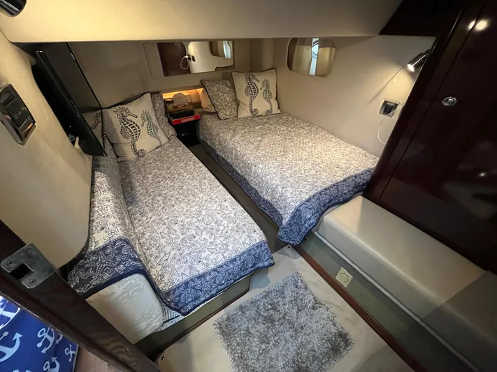 Lazy Days Yacht Photos Pics 2009 Sea Ray 44 Sedan Bridge twin bed cabin with nautical-themed bedding.