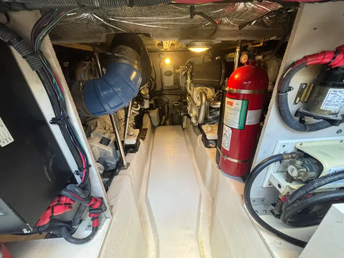Lazy Days Yacht Photos Pics Engine room of a 2009 Sea Ray 44 Sedan Bridge yacht, featuring mechanical components and fire extinguisher.