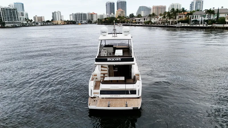 Bugsy Yacht Photos Pics 2020 Galeon 550 Fly yacht cruising in a city waterfront setting.