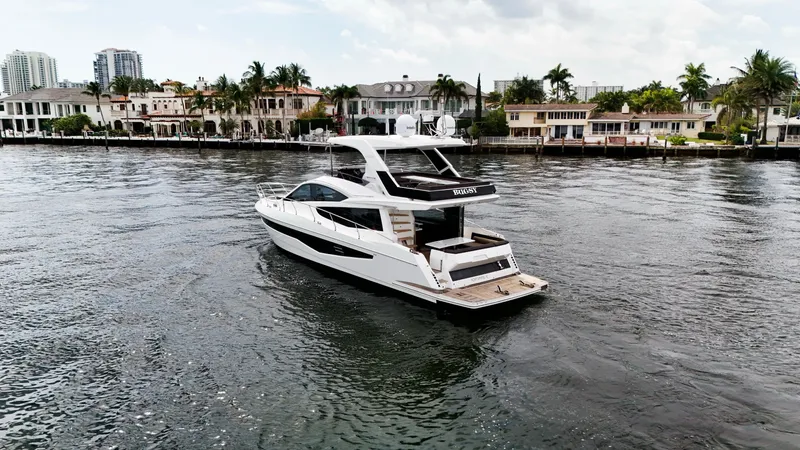 Bugsy Yacht Photos Pics 2020 Galeon 550 Fly yacht cruising near waterfront homes.