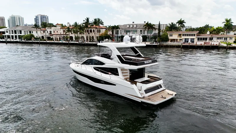 Bugsy Yacht Photos Pics 2020 Galeon 550 Fly yacht cruising near waterfront homes.