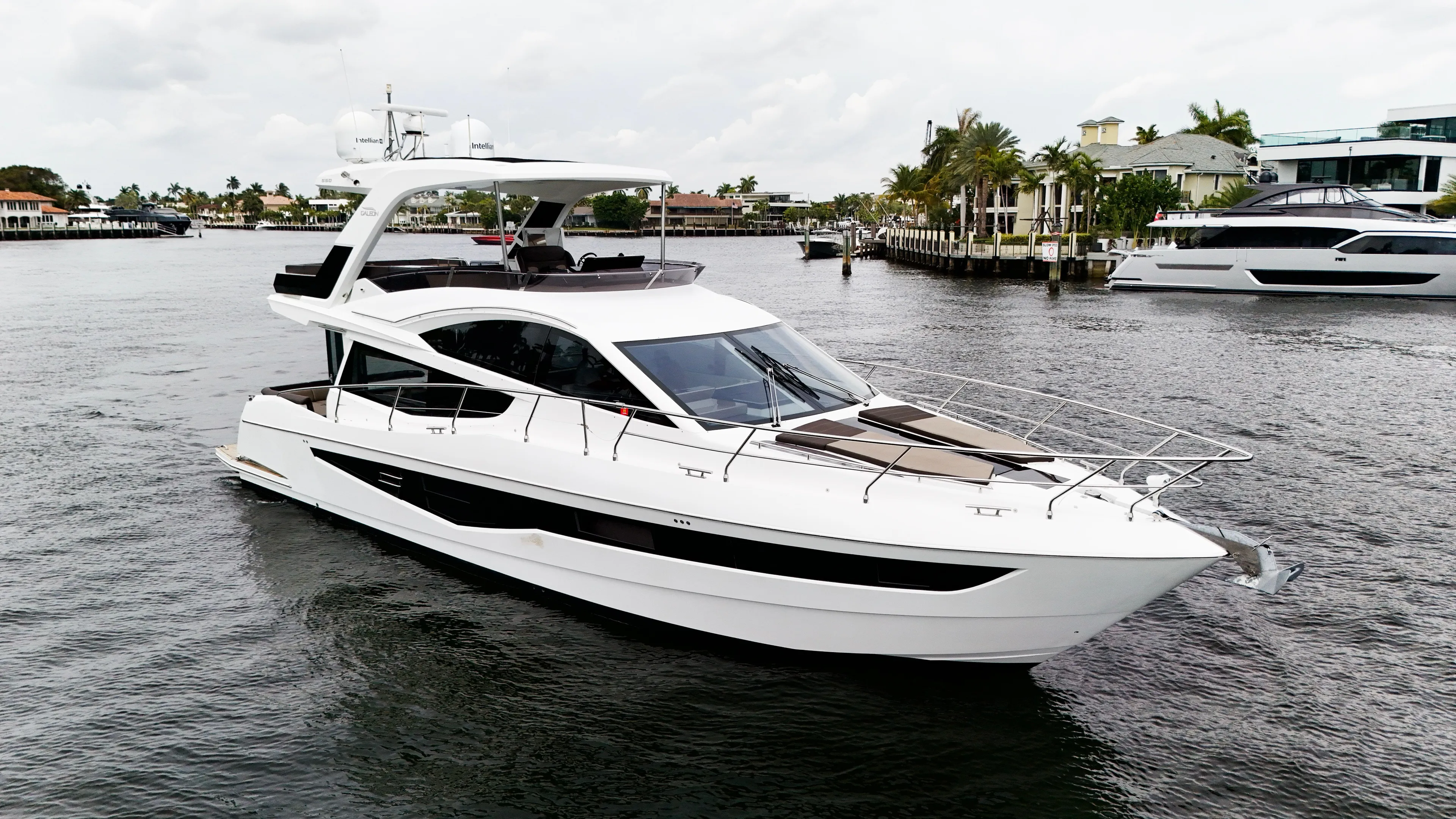 Bugsy Yacht Photos Pics 2020 Galeon 550 Fly yacht cruising on a calm waterway with modern design.