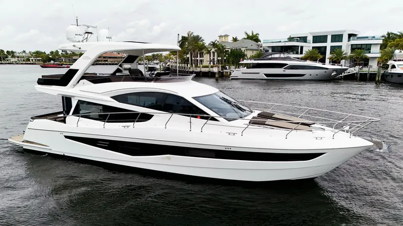 Bugsy Yacht Photos Pics 2020 Galeon 550 Fly yacht on water, showcasing sleek design and modern architecture.