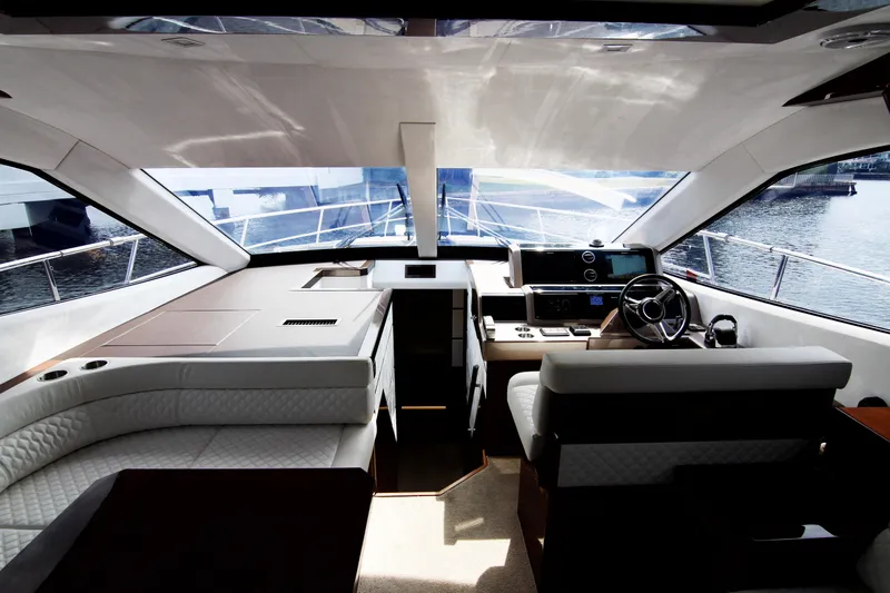 Bugsy Yacht Photos Pics Luxurious interior of 2020 Galeon 550 Fly yacht with modern helm and seating.
