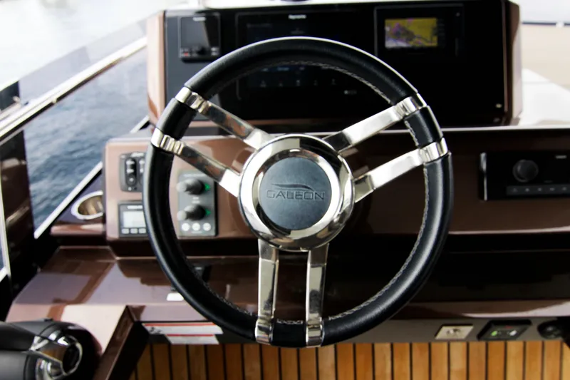 Bugsy Yacht Photos Pics Steering wheel of 2020 Galeon 550 Fly yacht, featuring modern controls and sleek design.