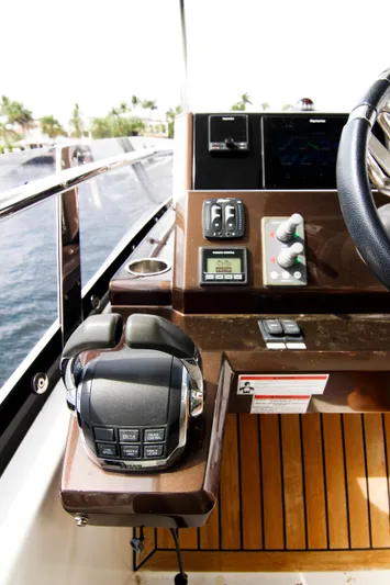 Bugsy Yacht Photos Pics Control panel of 2020 Galeon 550 Fly yacht with steering wheel and navigation controls.