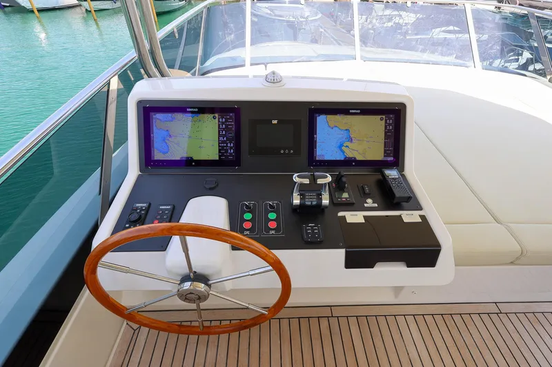Mas Que Nada Yacht Photos Pics 2021 Greenline OceanClass 68 yacht helm with dual navigation screens and wooden steering wheel.