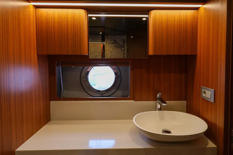 Mas Que Nada Yacht Photos Pics Luxury bathroom interior of 2021 Greenline OceanClass 68 yacht with modern sink and porthole.